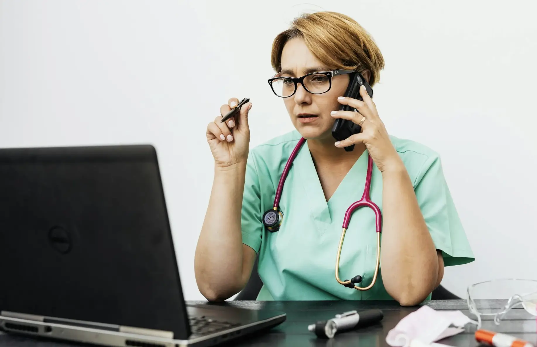 Healthcare professional managing administrative overload with multitasking tools and technology