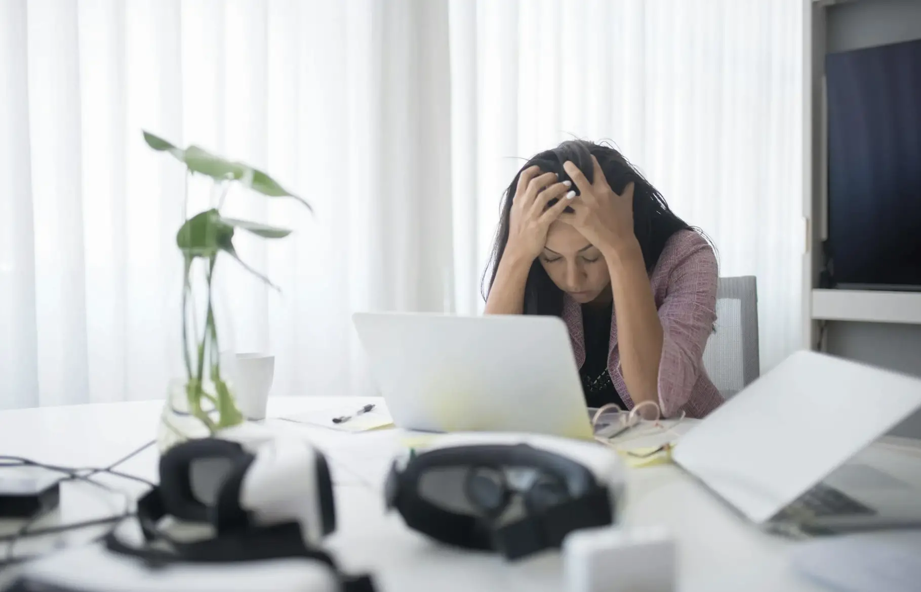 Healthcare Staffing Solutions for Clinical Burnout Relief Stressed healthcare worker at cluttered desk illustrating clinical burnout and need for healthcare staffing solutions.